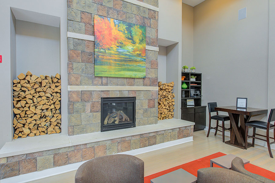 Fireplace at an outdoor hangout area located at One One Six Apartments.