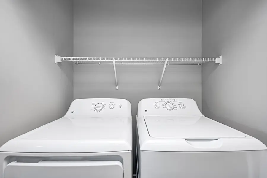 Choosing an apartment with in-unit laundry like this one at Continuum Apartments will give you more time for studying. A washer and dryer in an apartment laundry closet