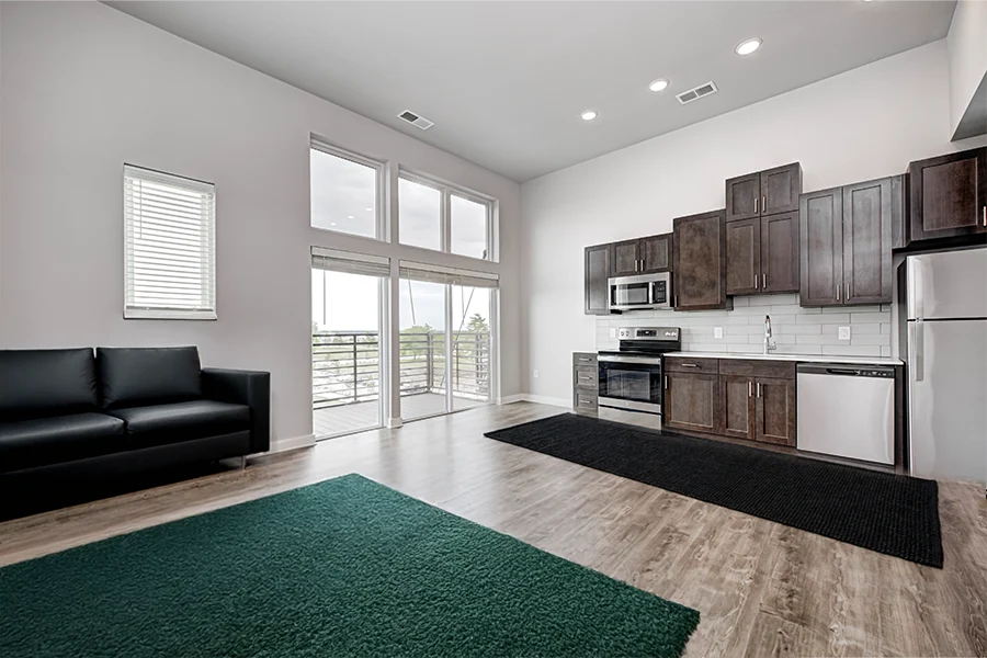 Now sure what colors to decorate with? Choose something to go with the existing finishes, like in this contemporary apartment at Continuum Apartments. apartment kitchen and living space with modern finishes